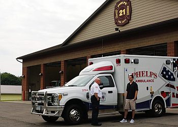 Two Men Standing in Front of Phelps Ambulance