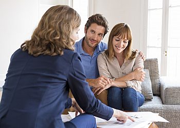 Couple Smiling While Meeting With Meeting with Financial Advisor
