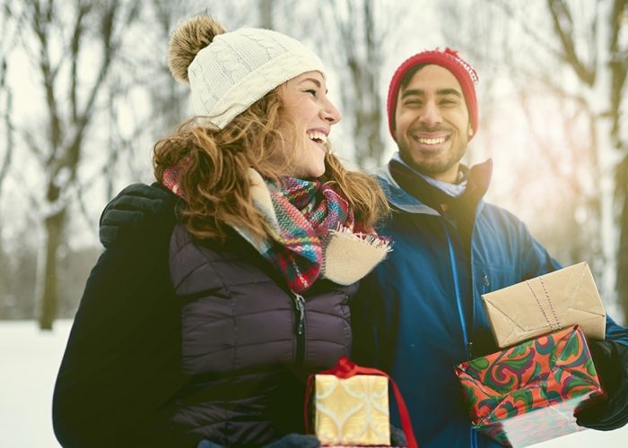 Couple in Winter Clothes Carrying Presents
